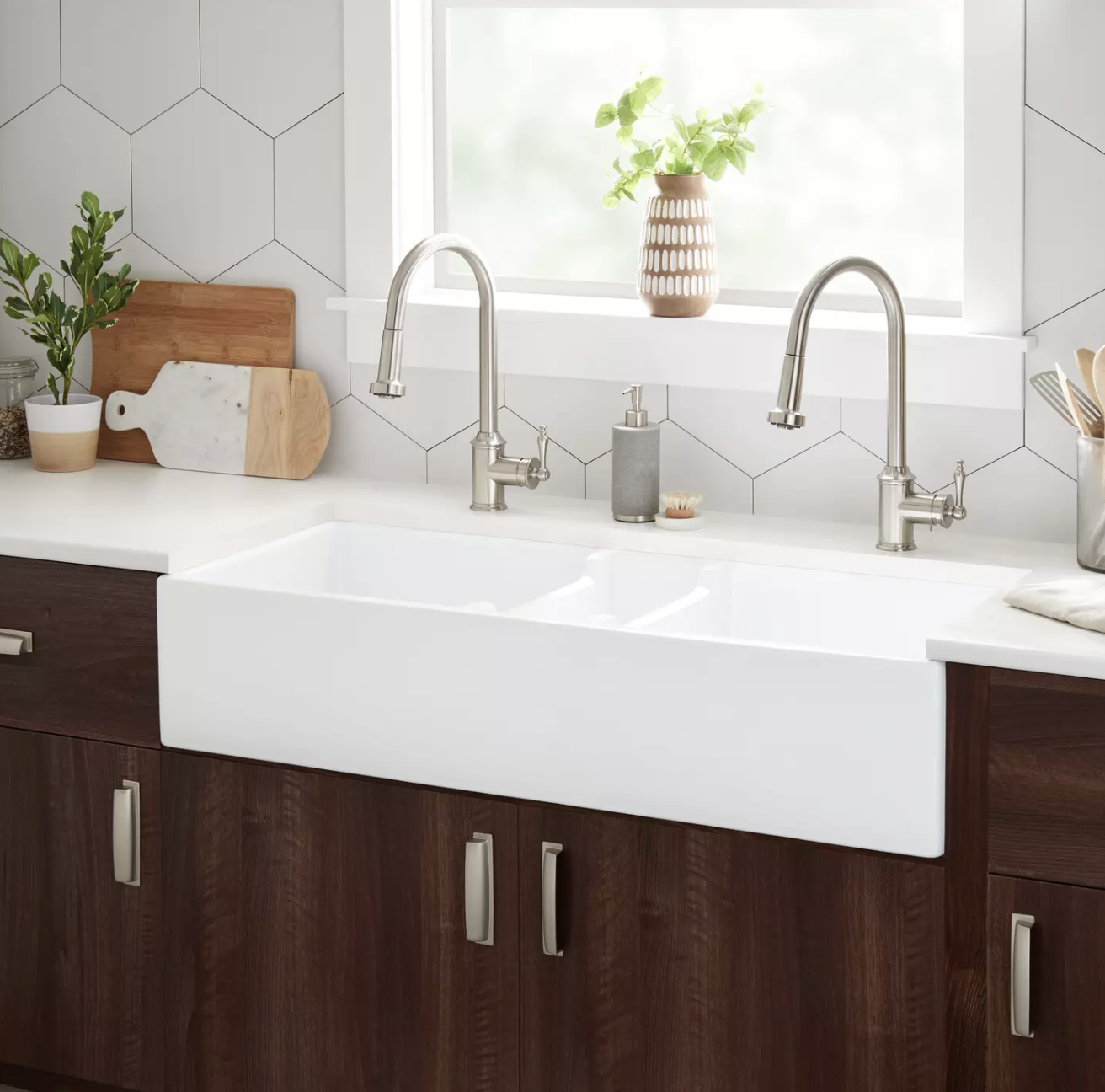 White 47-inch kitchen sink with dual satin nickel faucets in a luxury kitchen remodel