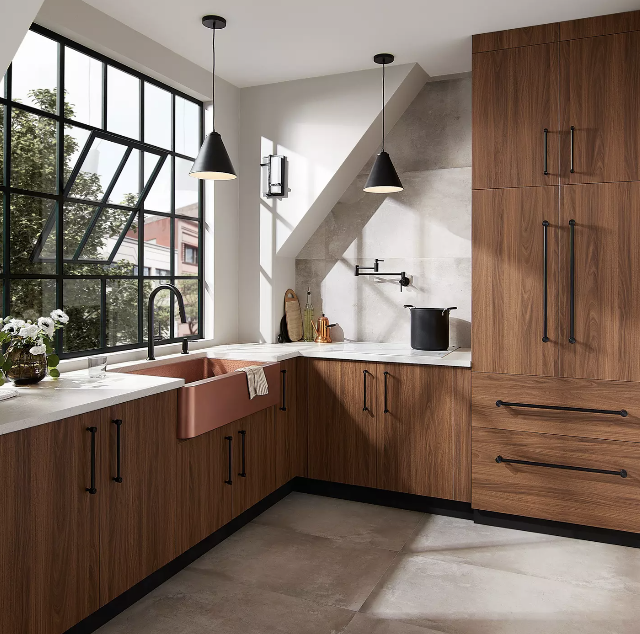 Luxury kitchen with medium-tone wood cabinets, white marble countertops, oil-rubbed bronze cabinet hardware, and a large copper farmhouse sink
